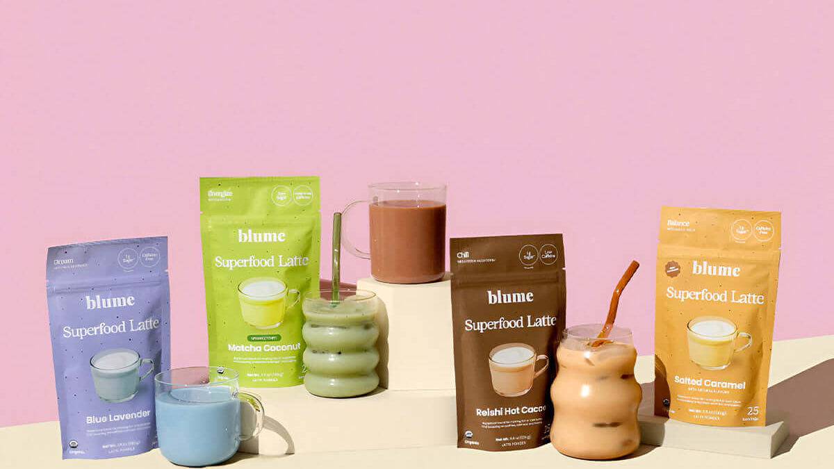 Blume Superfood Lattes packaging with cups and a pink background